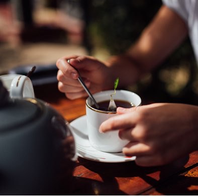 Stirring a cup of tea with infuser