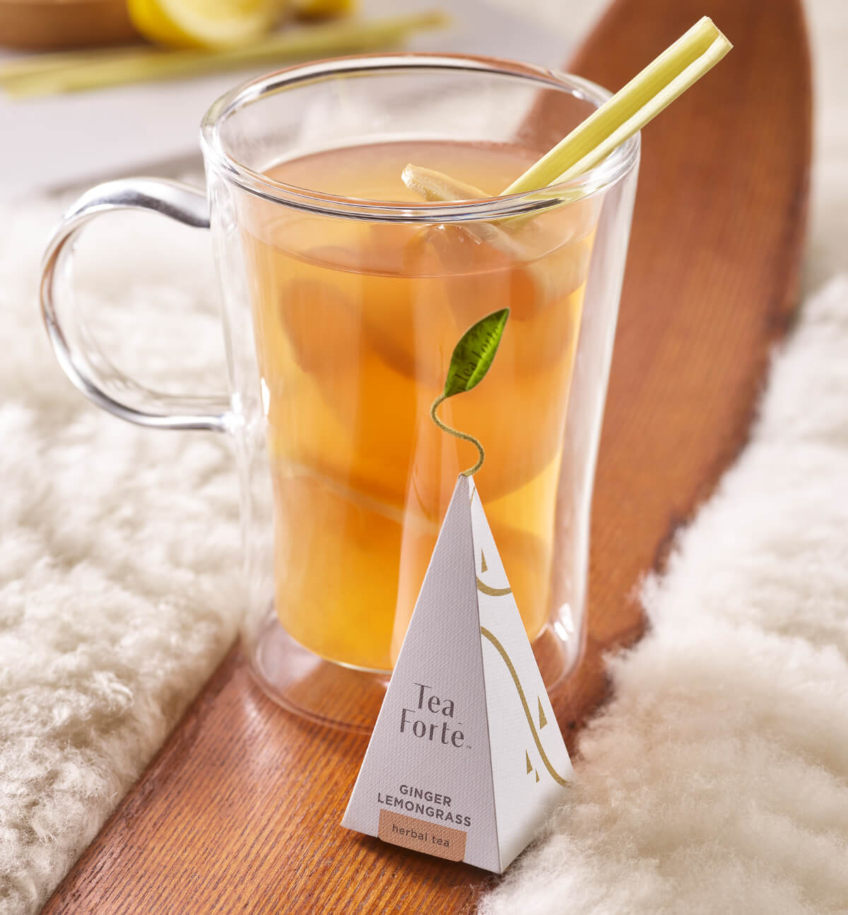 Ginger Lemongrass Hot Toddy in a glass mug with a pyramid infuser