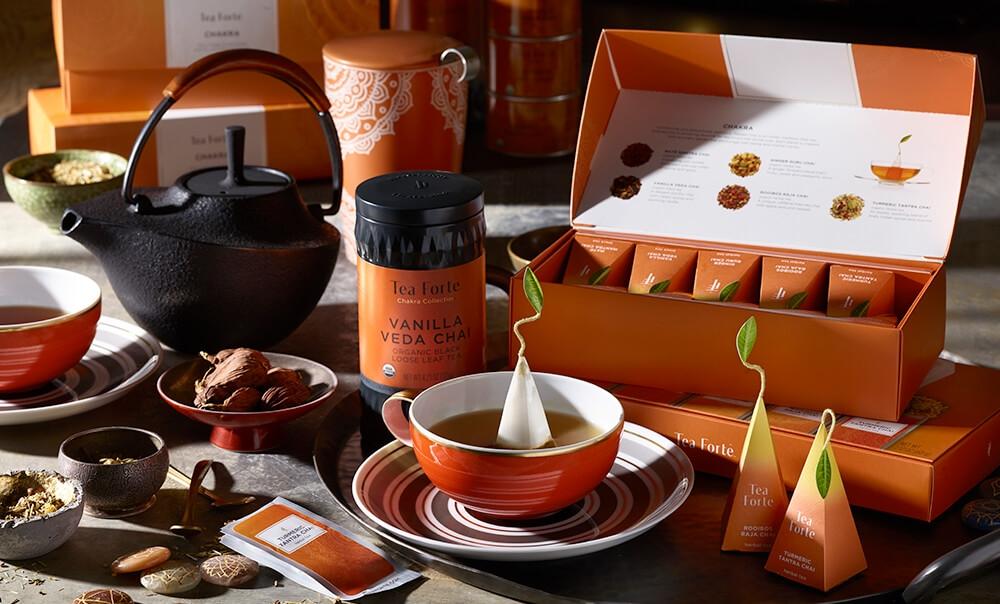 Chakra Collection on table with black iron teapot, spices and orange teacup