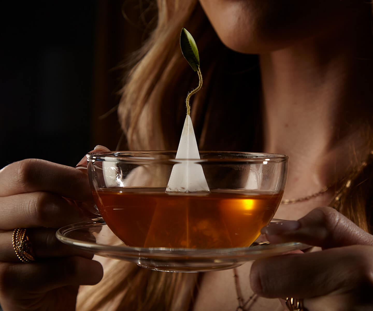 Holding a cup of black tea with infuser, steeping