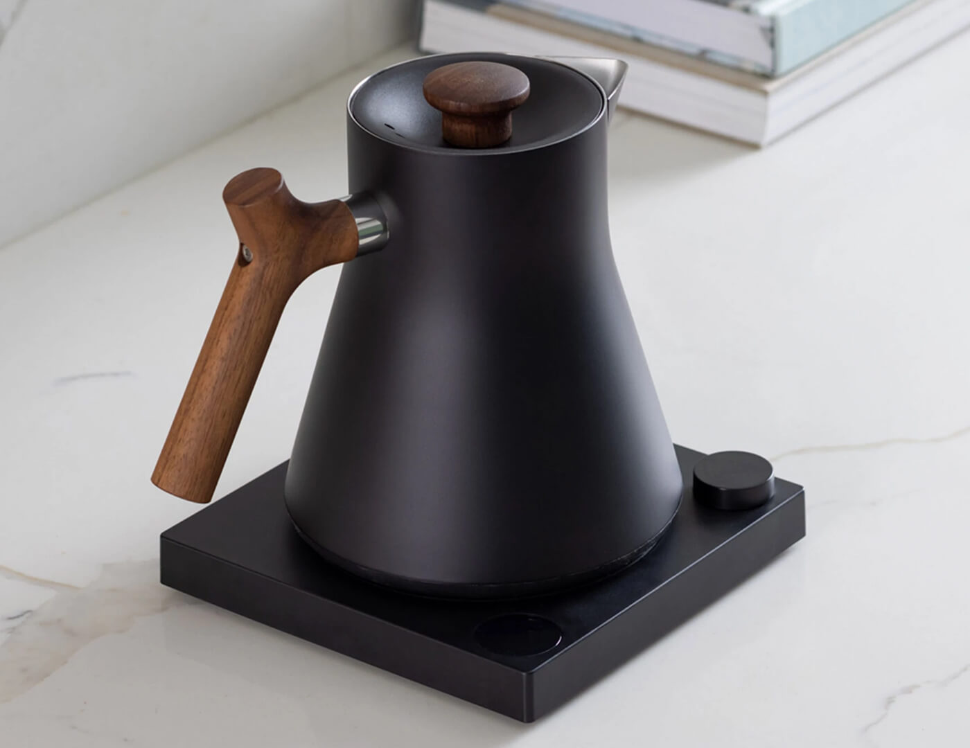 Black Corvo Kettle EKG with Walnut handle angled view, resting on base.