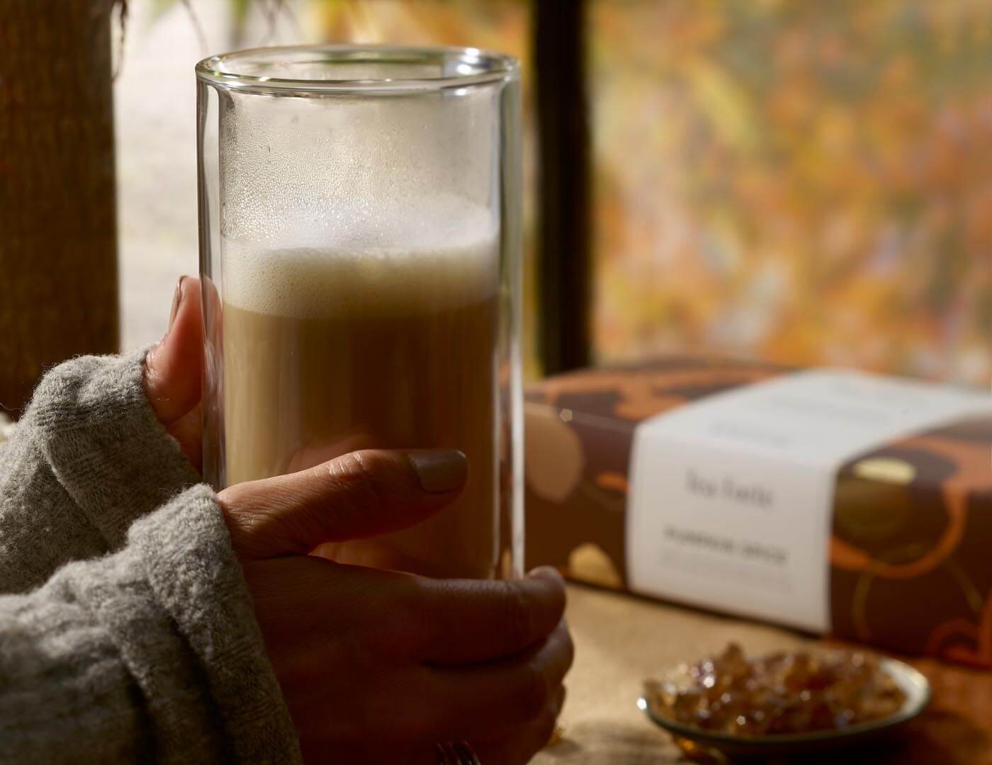 Holding a pumpkin Spice latte with petite box in background