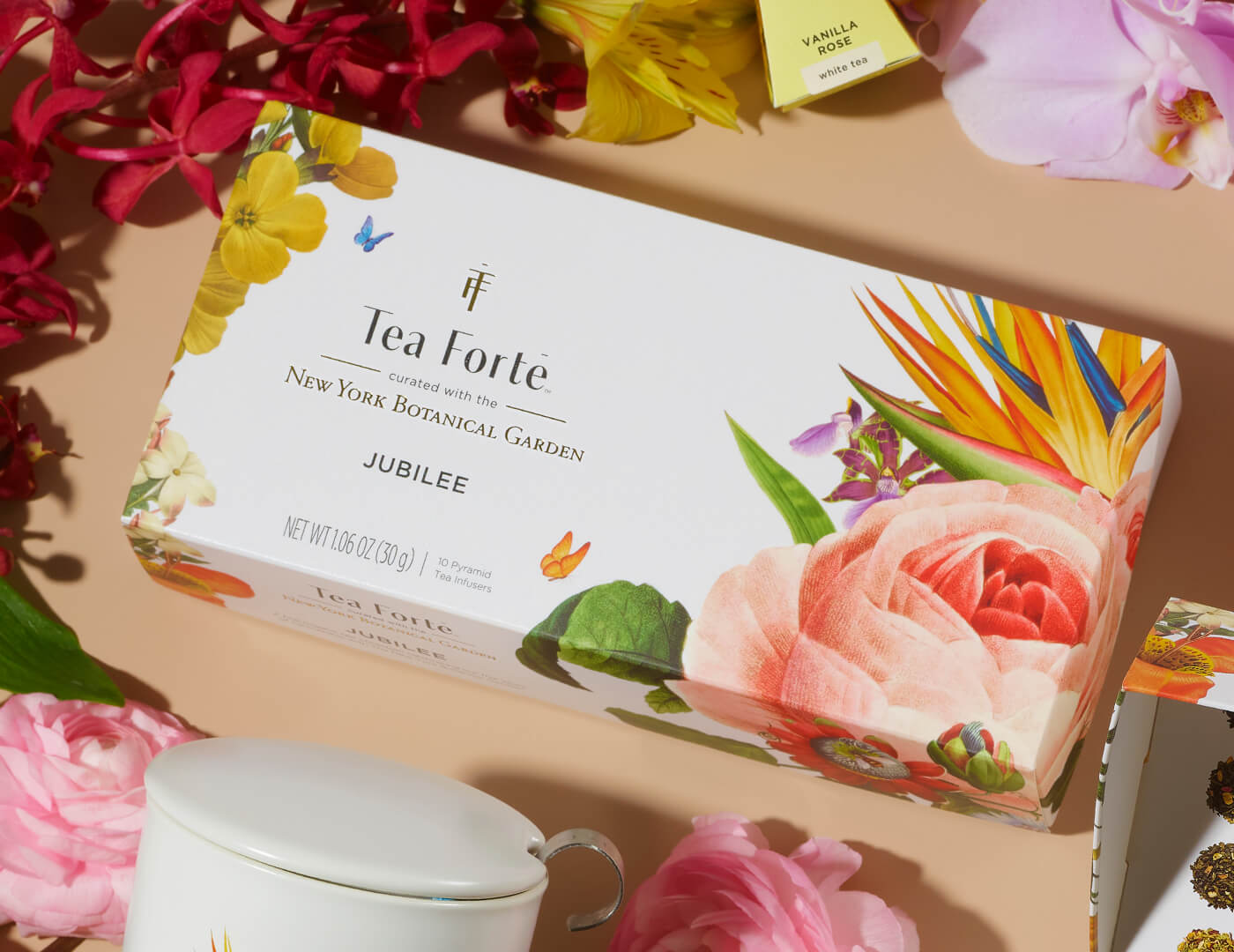 Jubilee Petite Presentation Box of 10 pyramid teas, lid closed, on a table of flowers and teas