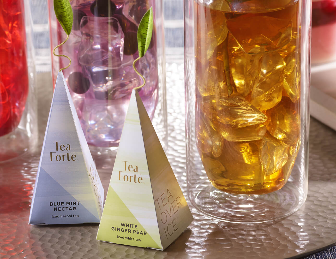 White Ginger Pear iced tea pyramid infuser with steeped iced tea and Blue Mint Necar infuser