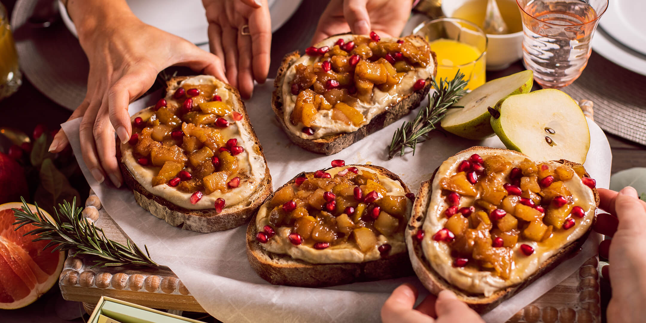 Multiple people taking a slice of Vanilla Pear Toast