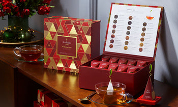 Warming Joy Tea Chests displayed on a table with teacups and ornaments