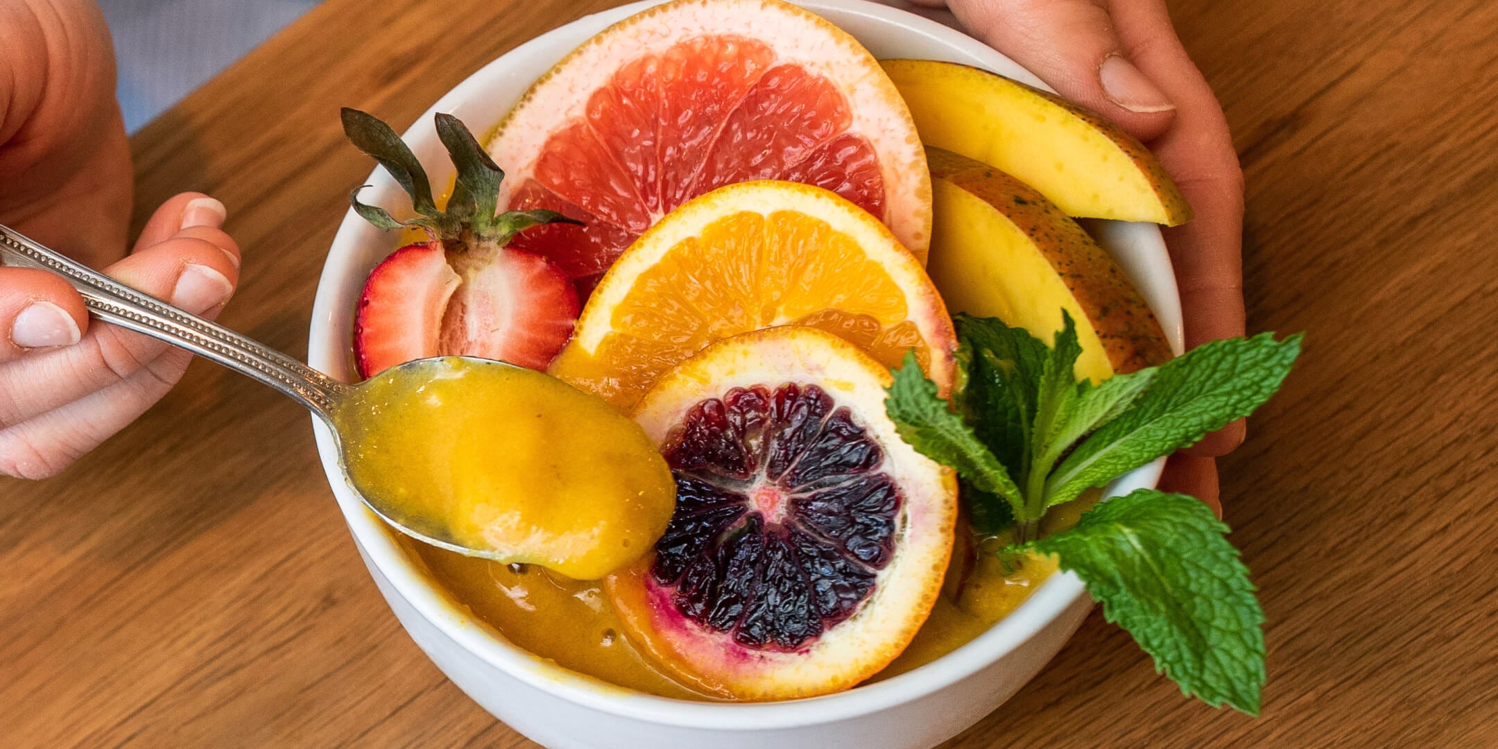 Mango Citron Smoothie in a bowl with fruit toppings