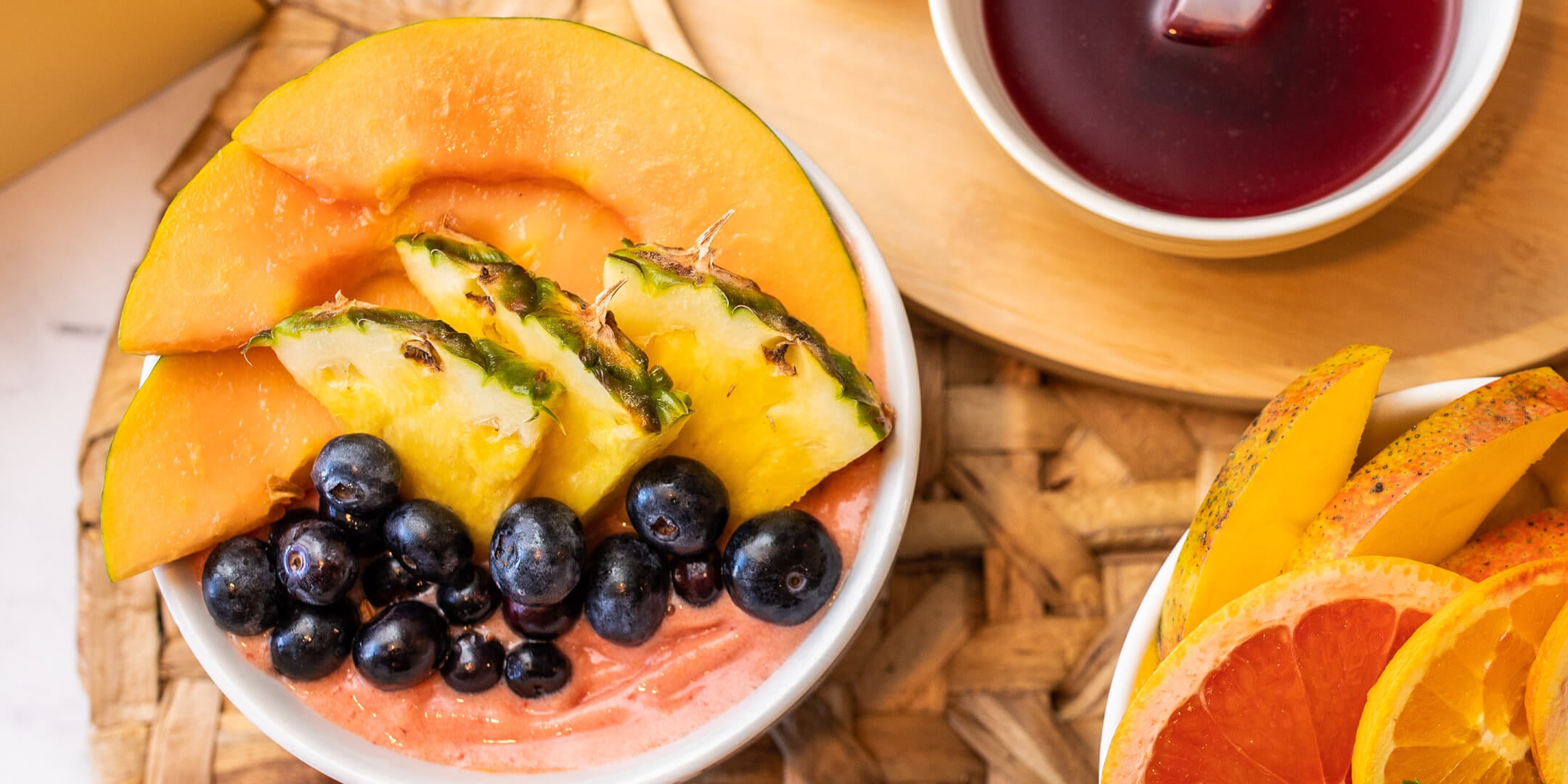 Orange Papaya Smoothie bowl from above with tea