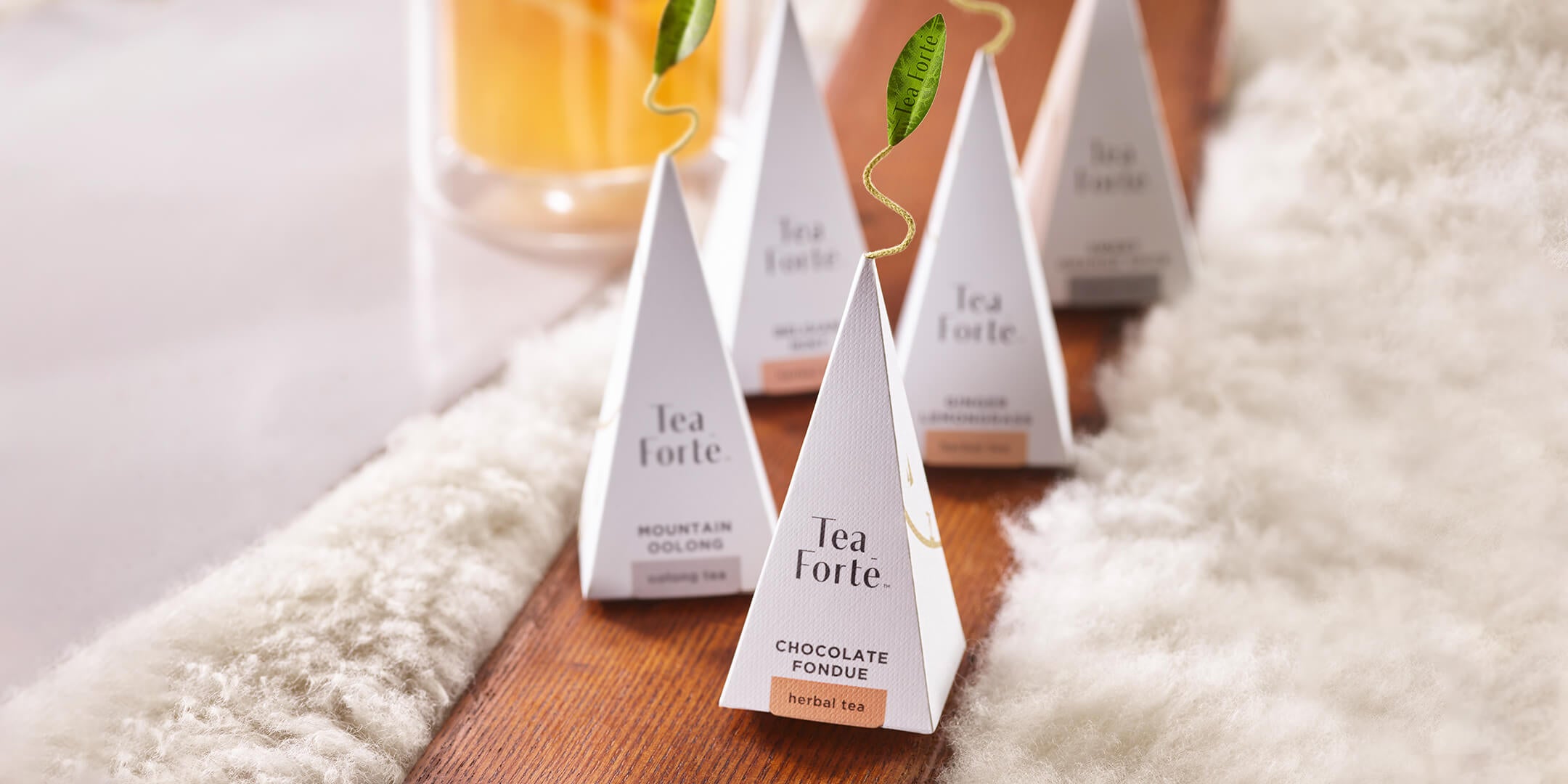 Winter Chalet pyramid infusers placed on a wooden ski