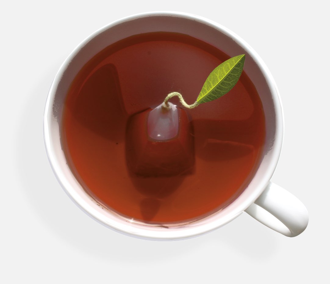 Café cup full of tea with a pyramid infuser inside, seen from above