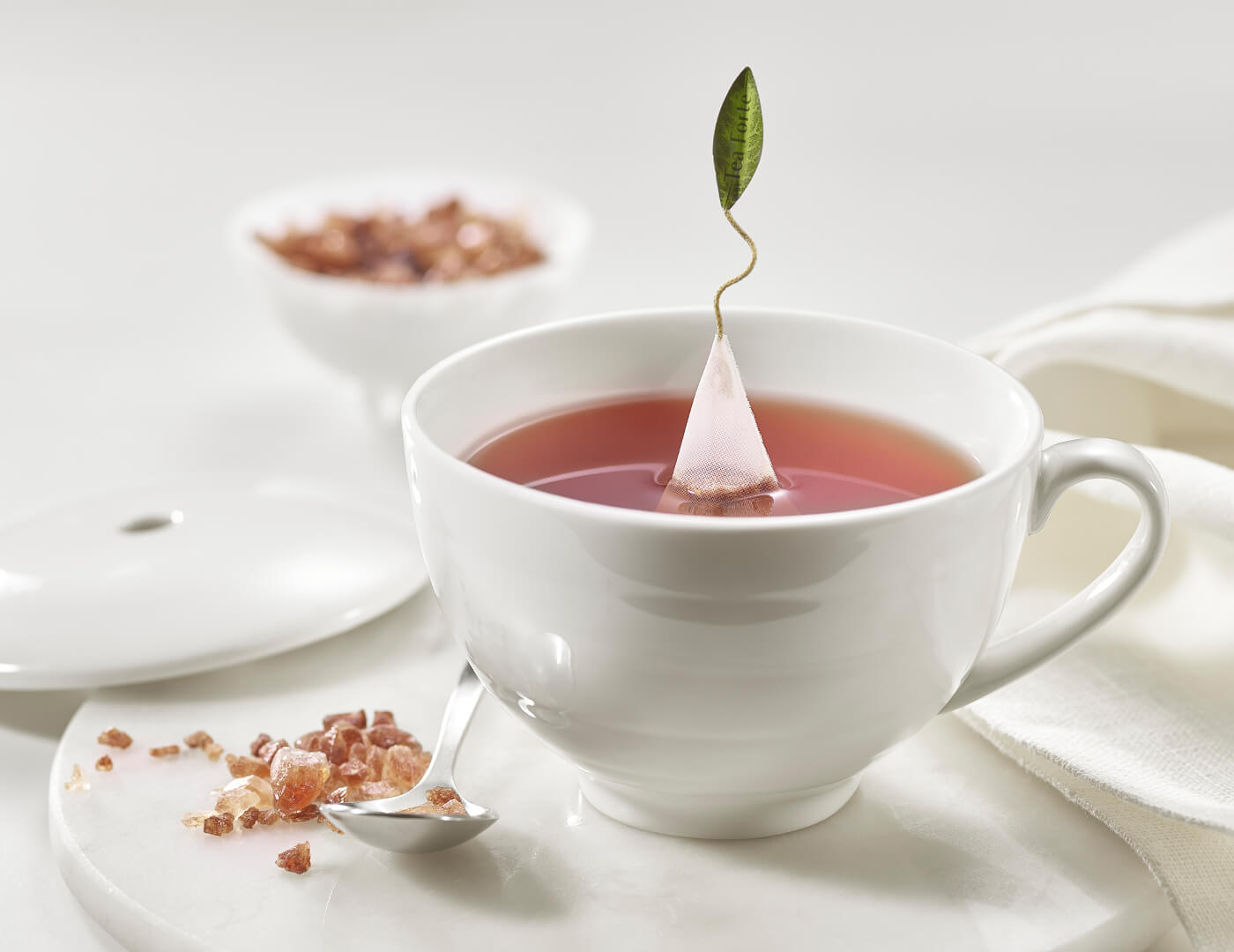 Café Cup with amber tea sugar and spoon